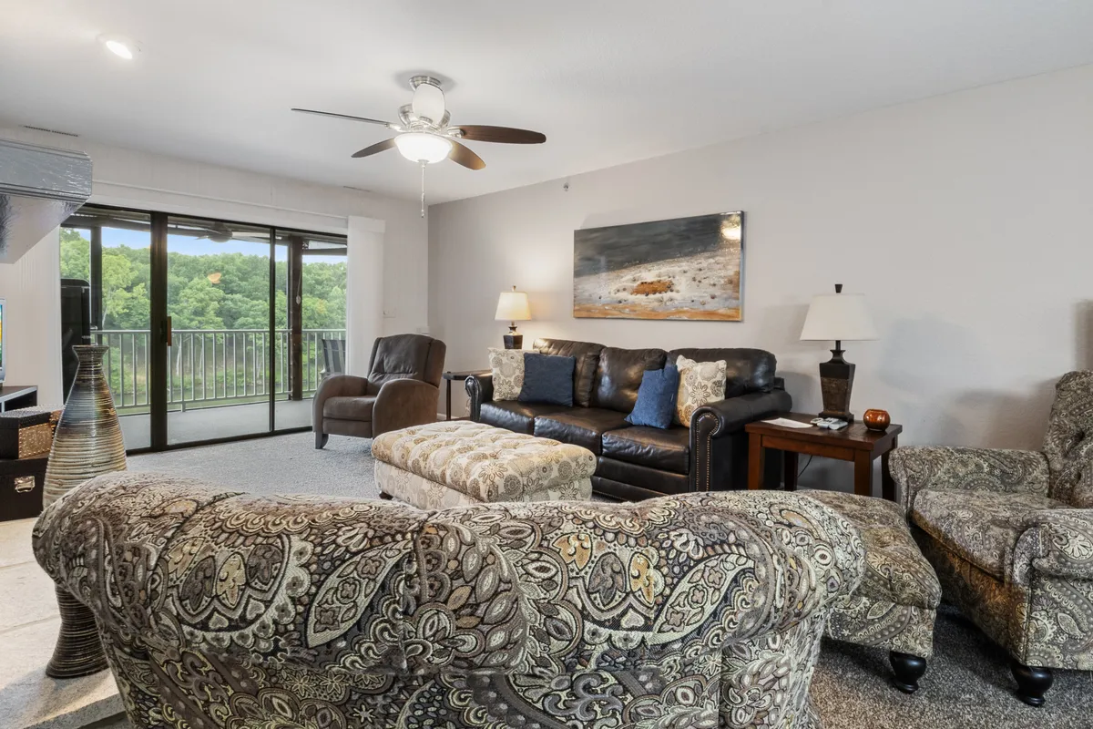 A cozy, pet-friendly living area featuring a comfortable sofa, decorative armchair, artwork on the wall, and a coffee table—all arranged in a way that suggests relaxation and family time.